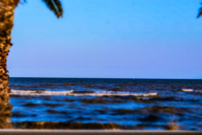 Scenic view of sea against clear blue sky