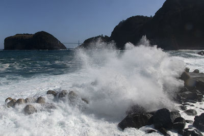 Waves splashing on rocks at shore