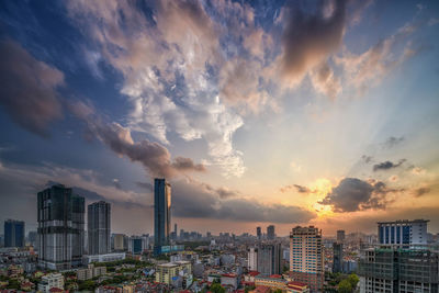 Buildings in city against sky during sunset