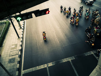 High angle view of people riding motorcycle on road