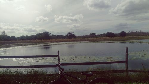 Scenic view of lake against cloudy sky