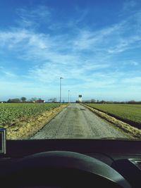 Country road passing through field