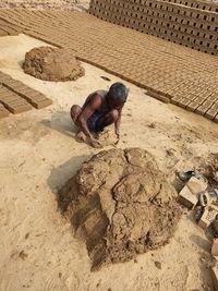 High angle view of man making bricks