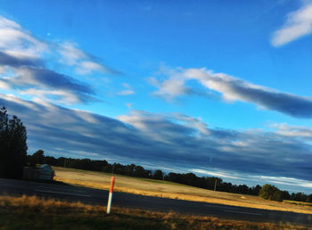 Scenic view of landscape against blue sky