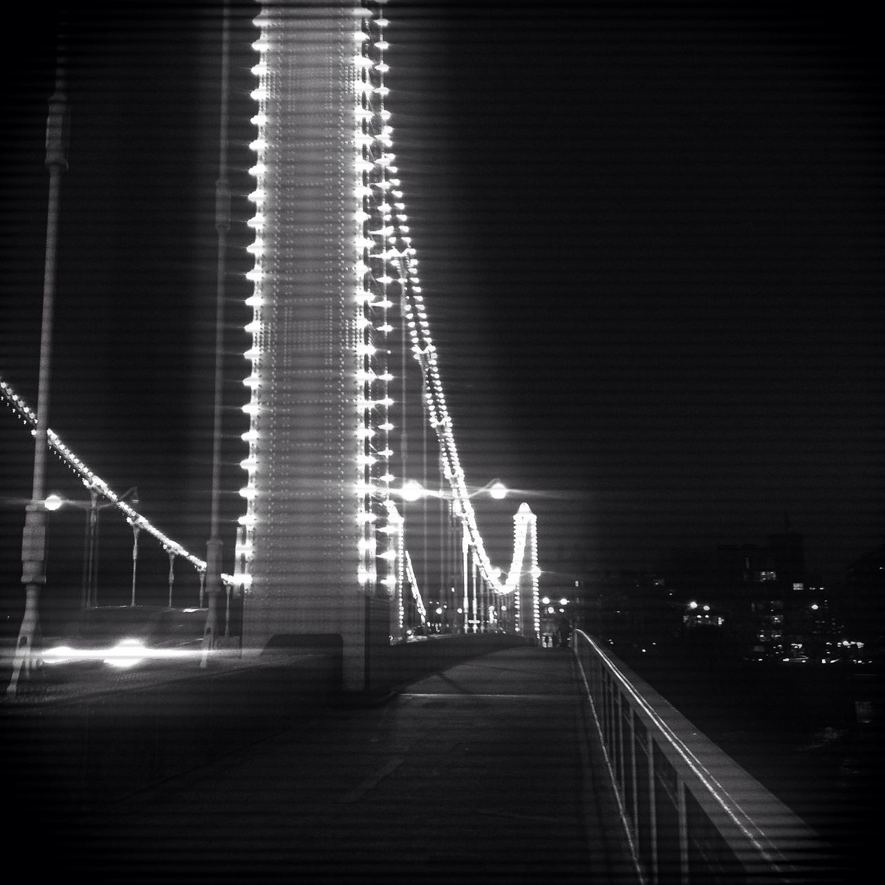 the way forward, illuminated, railing, built structure, architecture, night, diminishing perspective, connection, bridge - man made structure, vanishing point, lighting equipment, footbridge, walkway, street light, long, transportation, empty, narrow, sky, no people