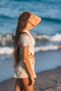 Young woman standing at beach