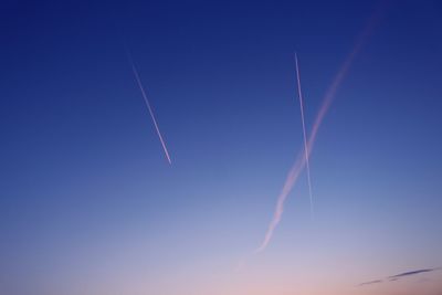 Low angle view of vapor trails in sky