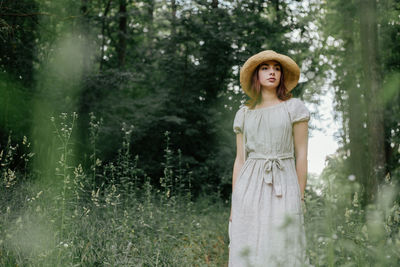 Woman standing in forest
