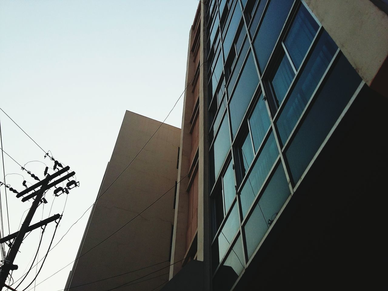 architecture, building exterior, built structure, low angle view, clear sky, city, office building, skyscraper, modern, tall - high, tower, building, sky, glass - material, outdoors, day, no people, tall, development, reflection