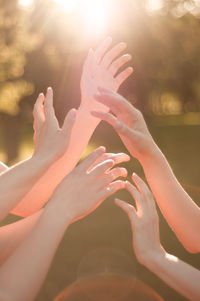 Cropped image of people hands against blurred background