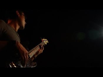 Man playing guitar at night