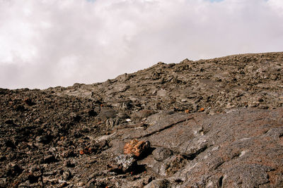 Low angle view of rocks on land against sky