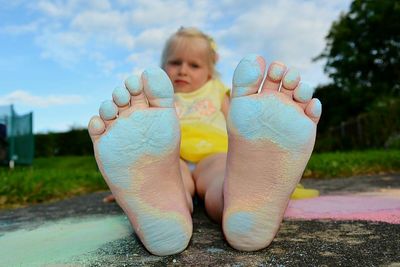 Close-up of girl with messy feet