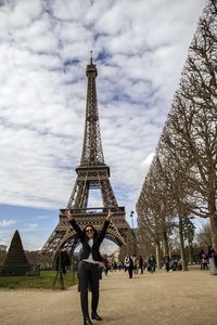 Tourists against cloudy sky