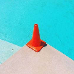 High angle view of orange traffic cone by swimming pool