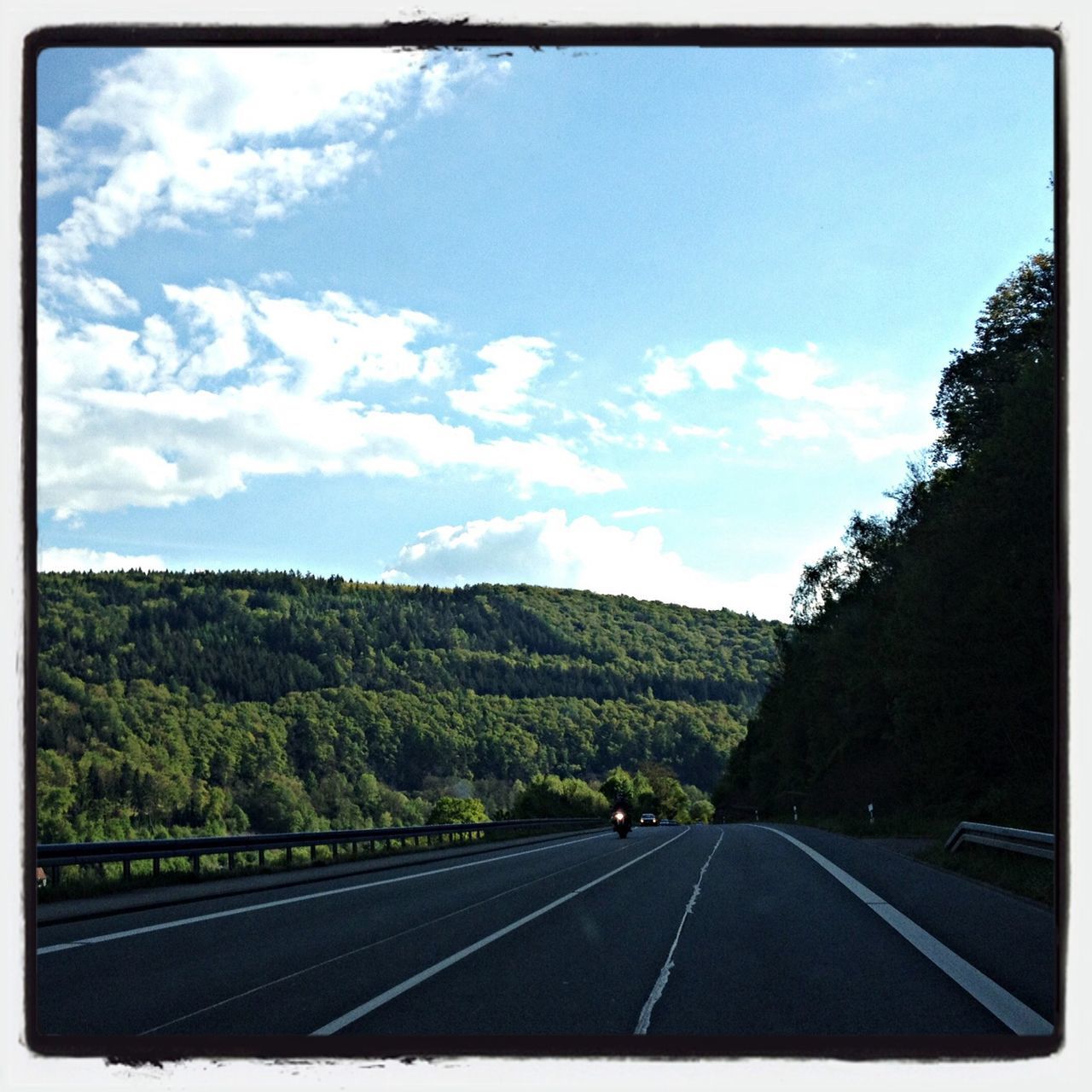 road, transportation, the way forward, road marking, sky, transfer print, diminishing perspective, country road, vanishing point, car, cloud - sky, cloud, tree, auto post production filter, landscape, highway, asphalt, empty, mountain, empty road