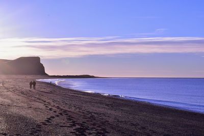 Scenic view of beach against sky during sunset