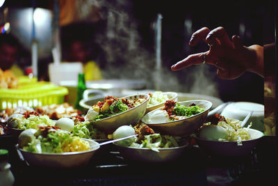 Midsection of person having food on table