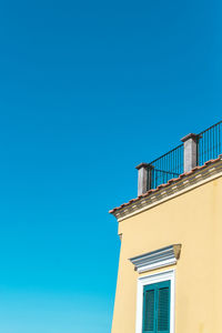 Low angle view of building against clear blue sky