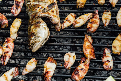 High angle view of meat on barbecue grill