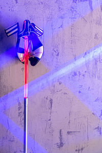 Close-up of street light against wall