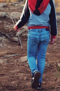 Full length of man holding umbrella while standing on land