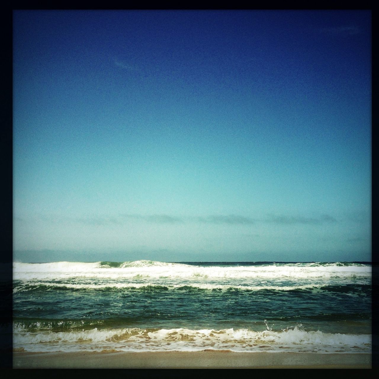 sea, water, horizon over water, transfer print, beach, clear sky, scenics, copy space, shore, tranquil scene, auto post production filter, tranquility, beauty in nature, wave, nature, sand, surf, blue, idyllic, coastline