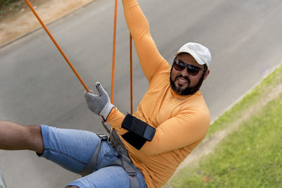 Man on a rappel rope looking at the camera