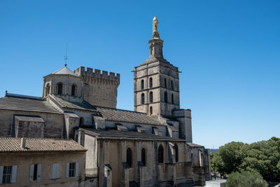 Low angle view of buildings against clear blue sky