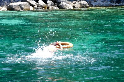 Man swimming in water