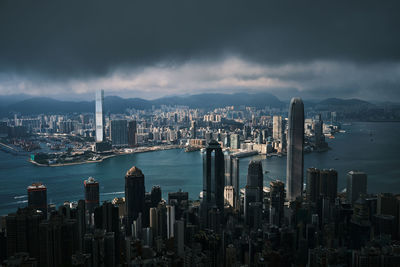 Aerial view of city against cloudy sky