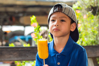 Close-up of boy eating corn