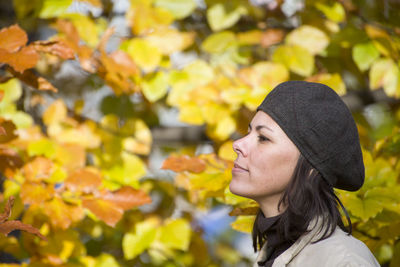 Woman looking at autumn leaves