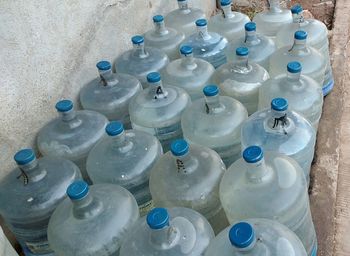 High angle view of bottles in container