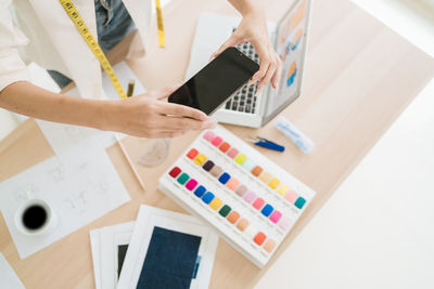 Midsection of business colleagues working on table