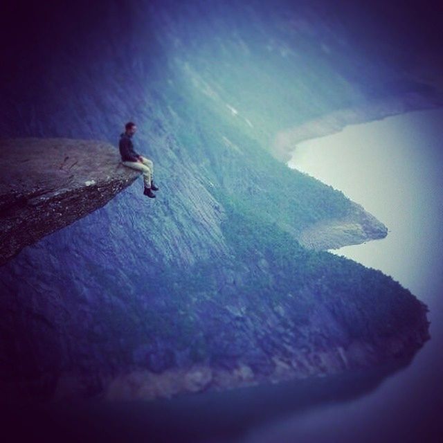 sea, leisure activity, lifestyles, full length, sky, men, rock - object, beauty in nature, scenics, nature, mid-air, water, tranquil scene, tranquility, flying, blue, rock formation, unrecognizable person