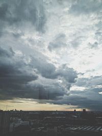 Cityscape against cloudy sky