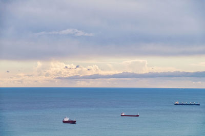 Scenic view of sea and fright transportation with ships against sky