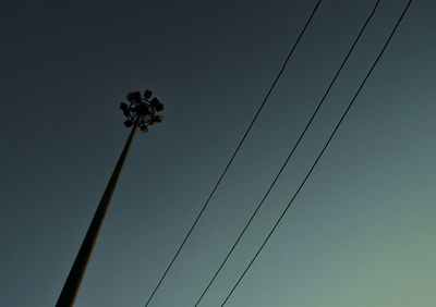 Low angle view of floodlight against clear blue sky