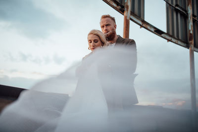 Rear view of couple holding hands