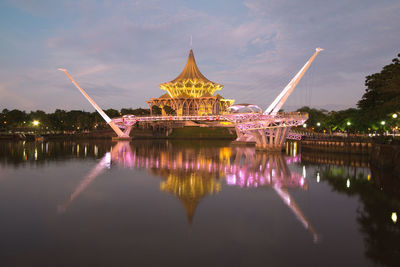 Illuminated temple against sky at night