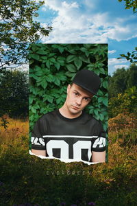 Portrait of young man against trees