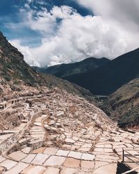 Aerial view of mountain range against cloudy sky