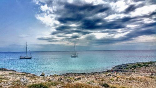 Scenic view of sea against cloudy sky