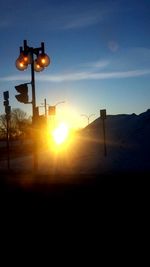 Street light against sky at sunset