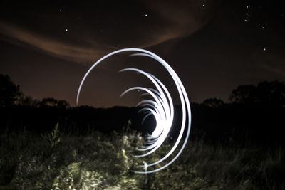 Low angle view of spiral staircase against sky at night