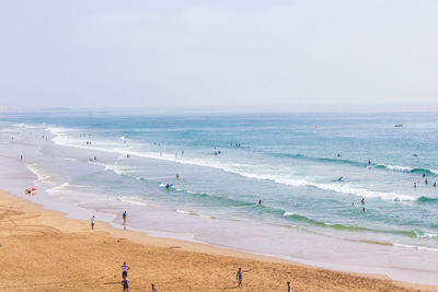 People on beach against sky