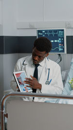 Doctor showing digital tablet in hospital