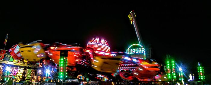 Low angle view of ferris wheel at night