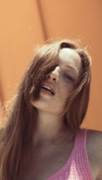 Close-up portrait of young woman with brown hair